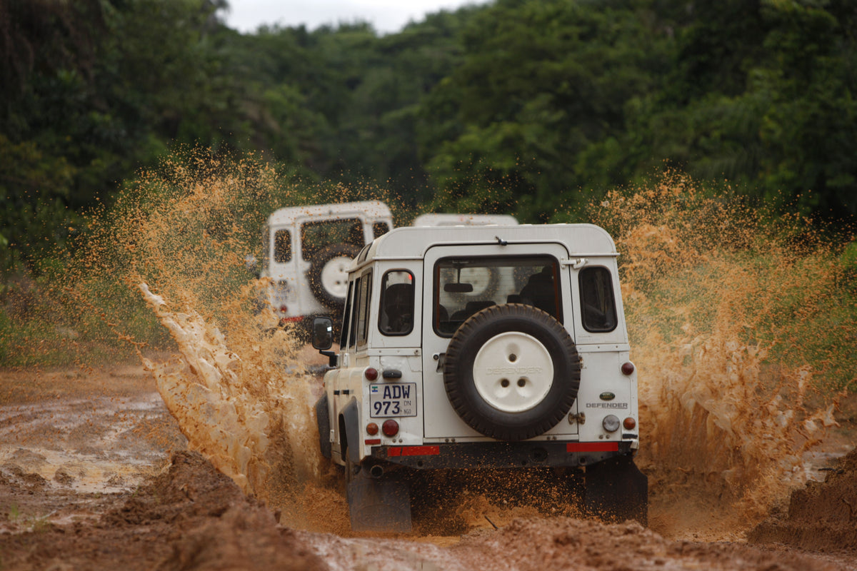 Land Rover Defender driving off-road through water