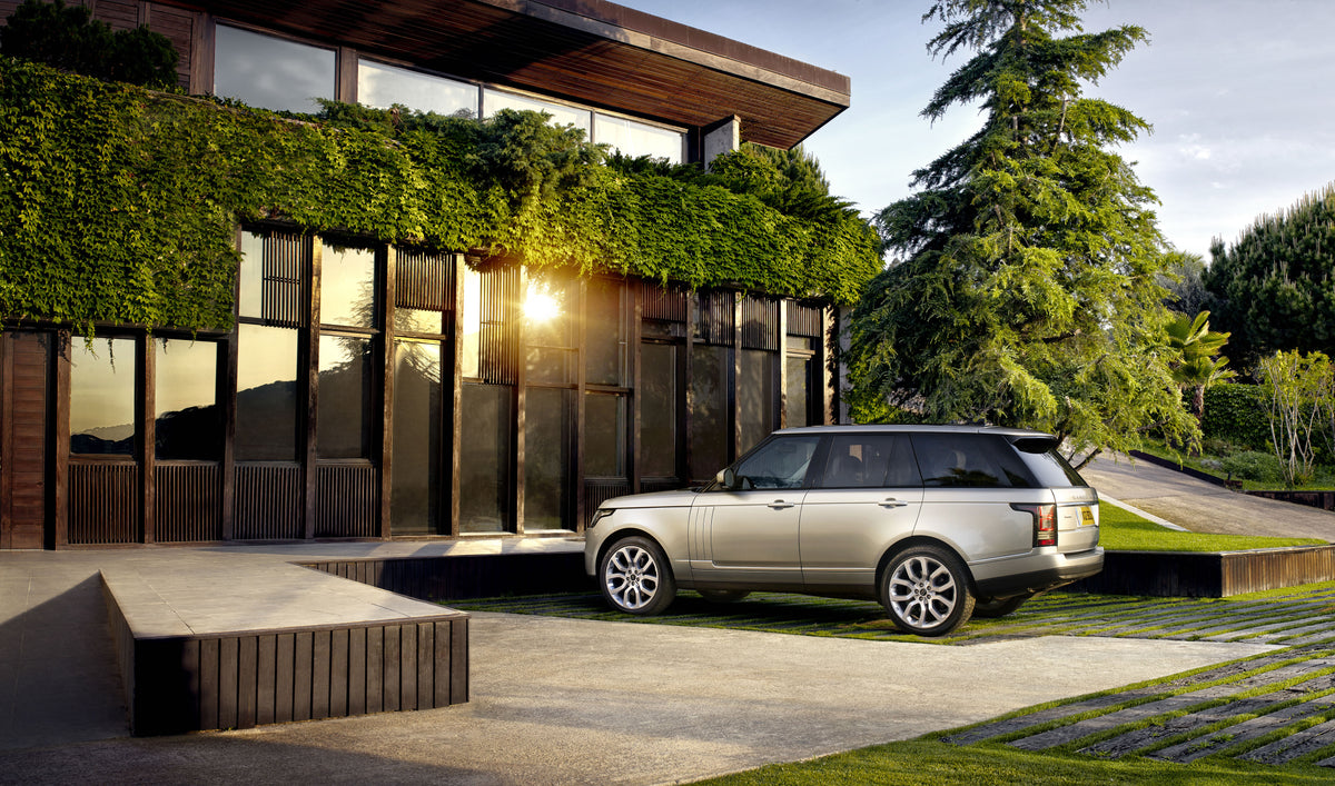 Range Rover parked outside a modern house